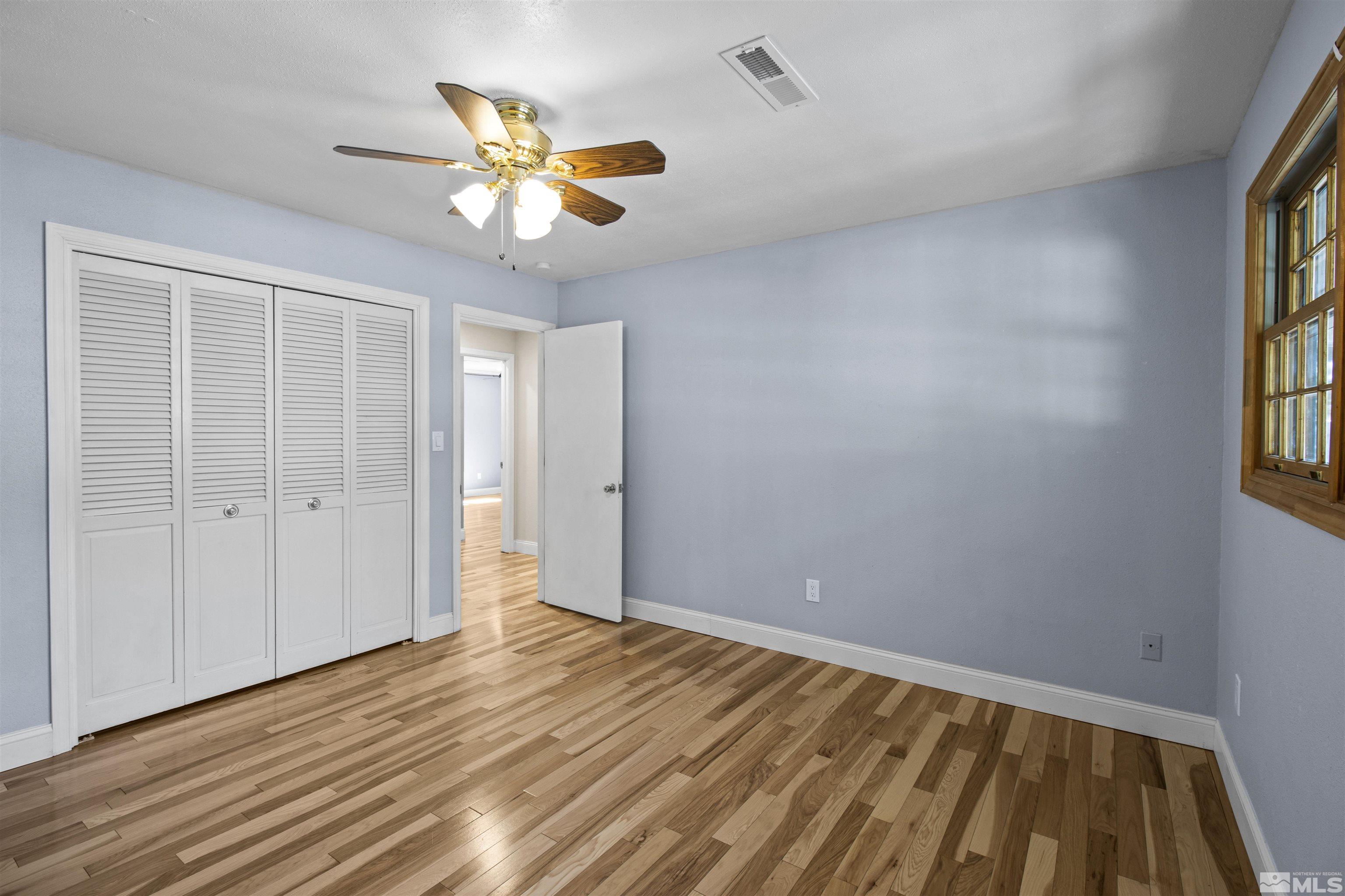 14285 Virginia Foothills Drive Reno, NV 89521 - Photo 36 of 39 wooden floor in an empty room with a window