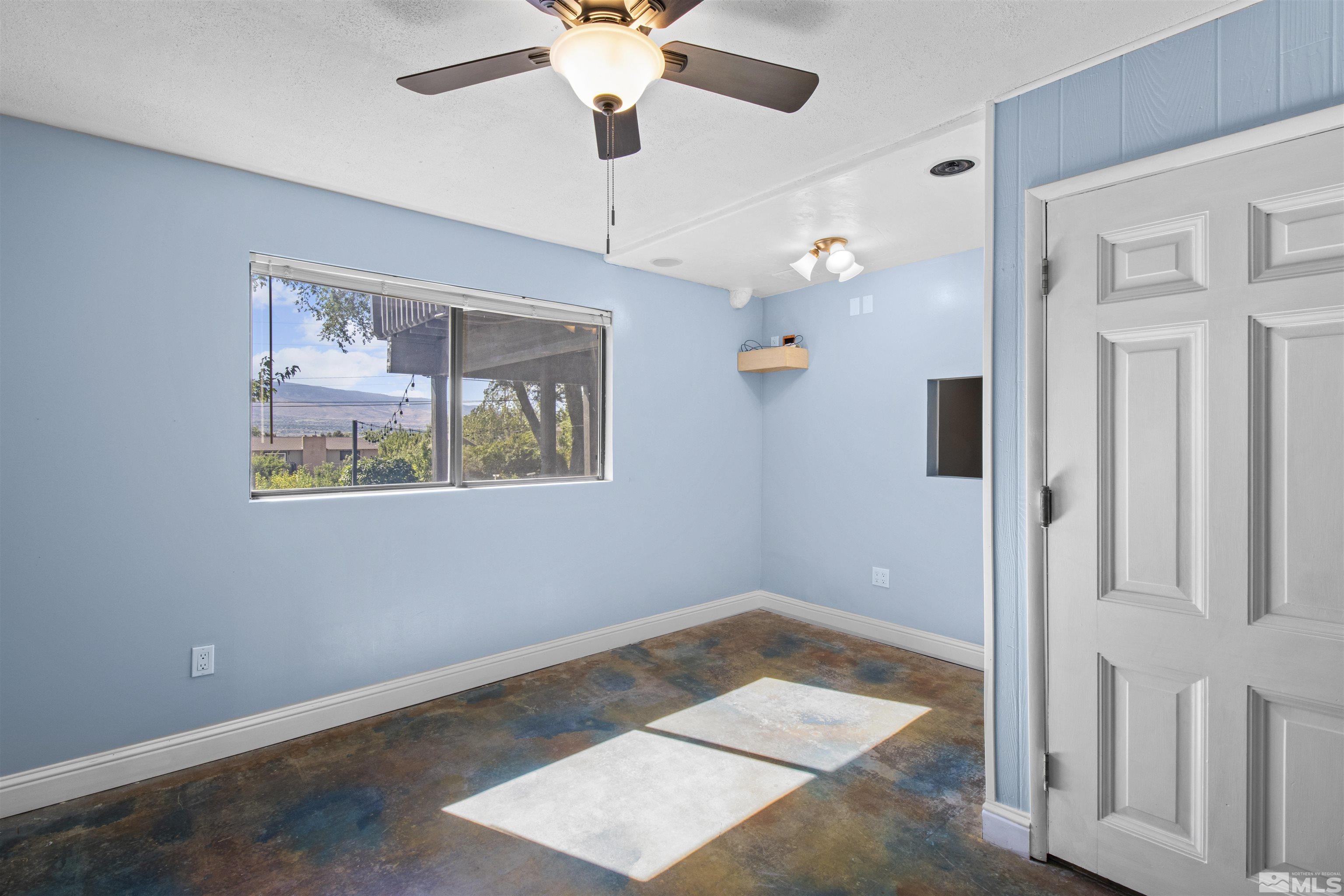 14285 Virginia Foothills Drive Reno, NV 89521 - Photo 38 of 39 an empty room with fan and windows