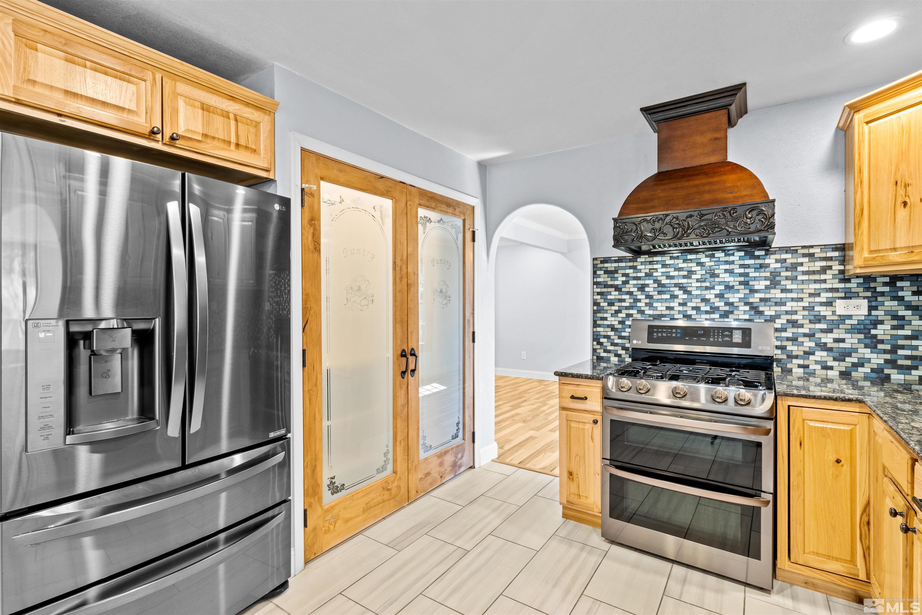 14285 Virginia Foothills Drive Reno, NV 89521 - Photo 4 of 39 a kitchen with stainless steel appliances granite countertop a refrigerator and a stove