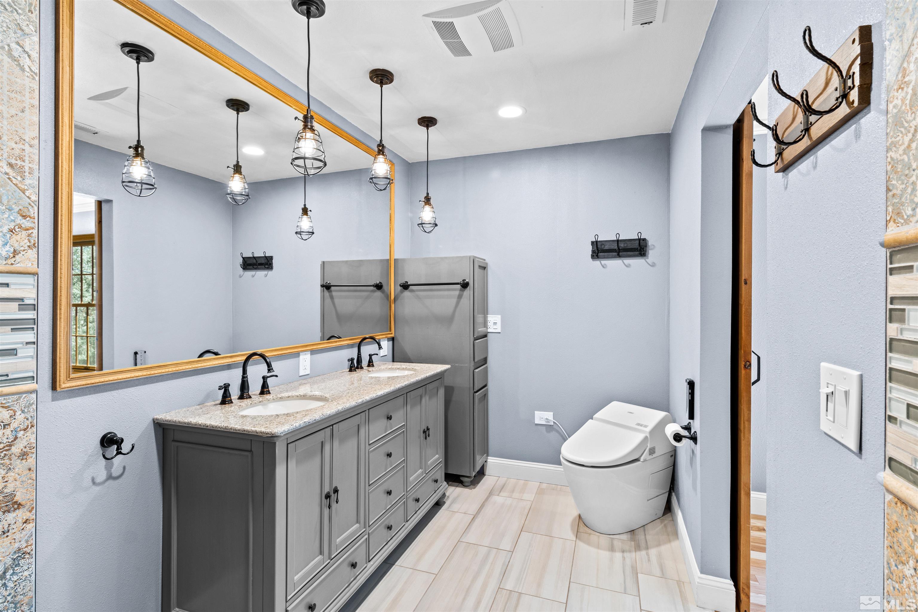 14285 Virginia Foothills Drive Reno, NV 89521 - Photo 10 of 39 a bathroom with a sink a toilet and a mirror