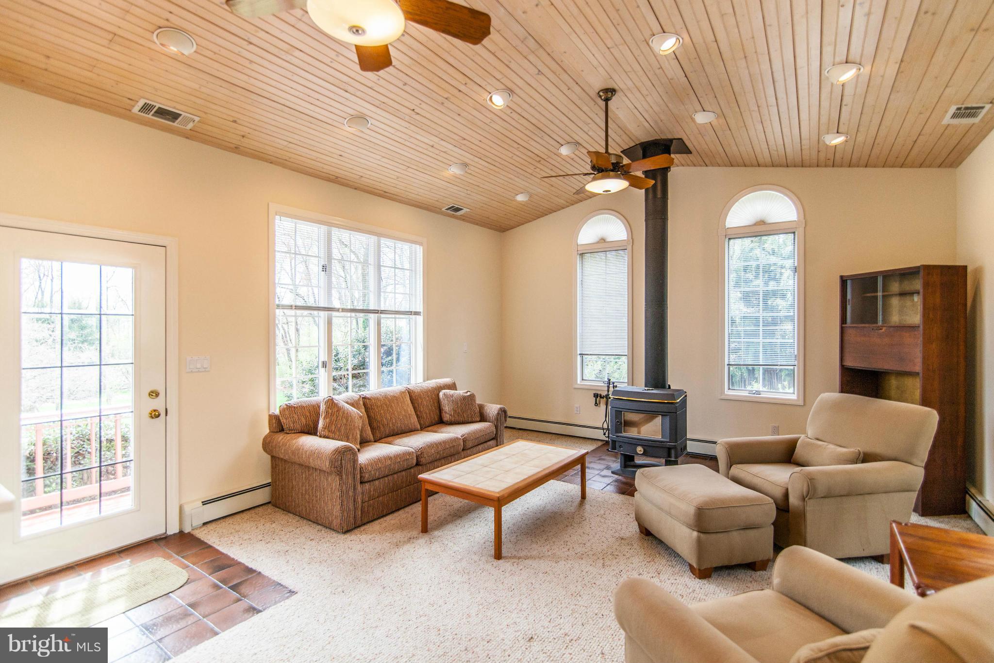 13407 Roxbury Road Silver Spring, MD 20904 - Photo 2 of 23 a living room with furniture ceiling fan and a large window