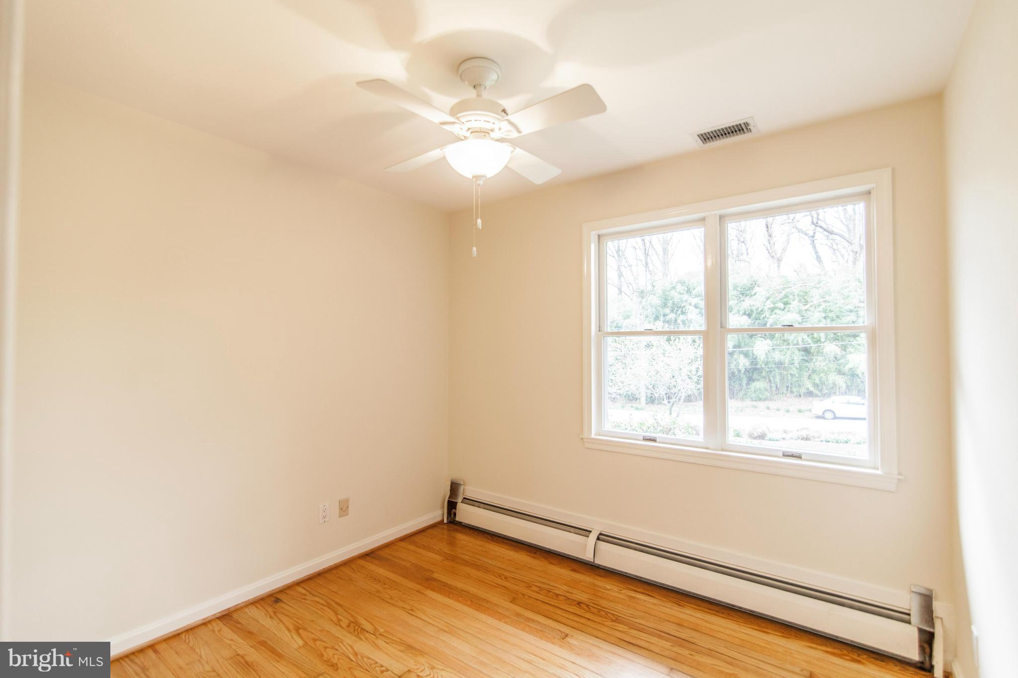 13407 Roxbury Road Silver Spring, MD 20904 - Photo 11 of 23 a view of an empty room with wooden floor and a window