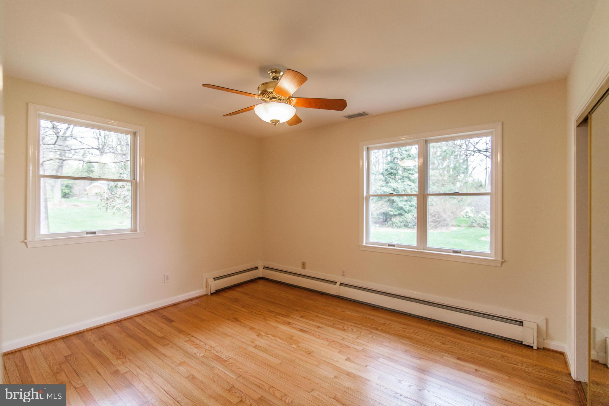 13407 Roxbury Road Silver Spring, MD 20904 - Photo 12 of 23 a view of an empty room with wooden floor and a window