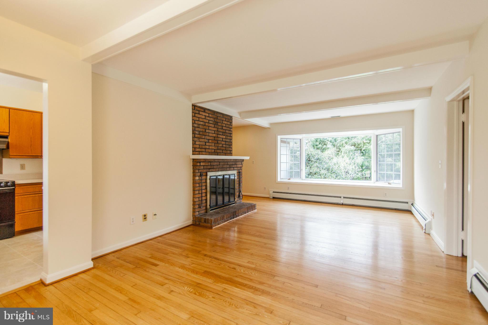 13407 Roxbury Road Silver Spring, MD 20904 - Photo 5 of 23 a view of an empty room with a window and wooden floor