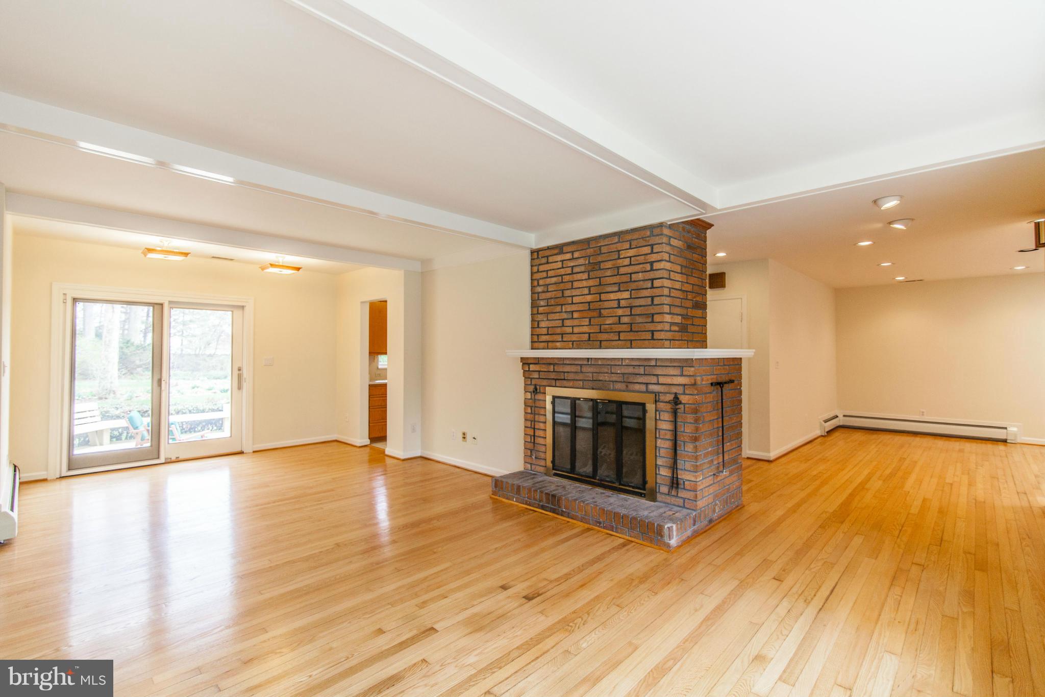 13407 Roxbury Road Silver Spring, MD 20904 - Photo 6 of 23 a view of an empty room with wooden floor and a fireplace