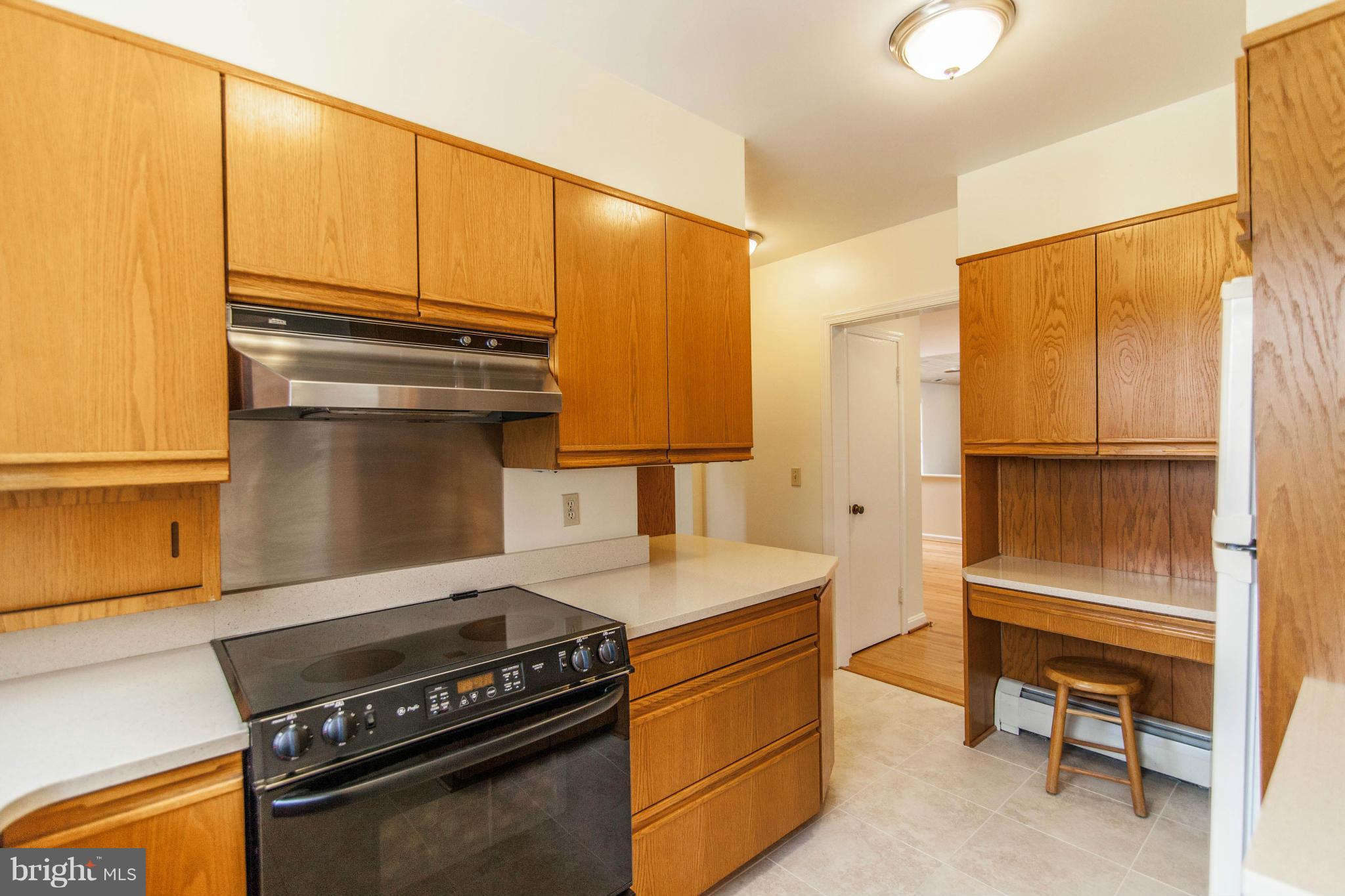 13407 Roxbury Road Silver Spring, MD 20904 - Photo 7 of 23 a kitchen with a stove and a microwave