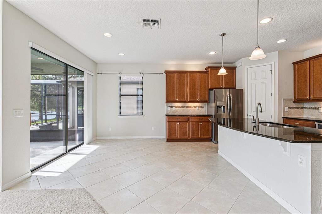 7137 Beek Street Windermere, FL 34786 - Photo 11 of 33 a large kitchen with cabinets and stainless steel appliances