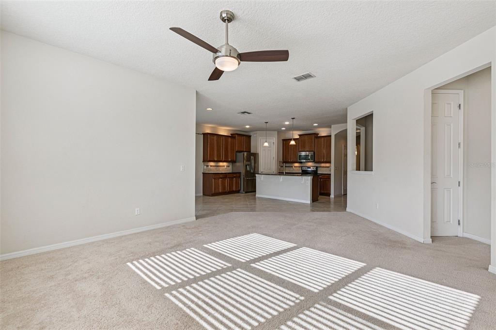 7137 Beek Street Windermere, FL 34786 - Photo 16 of 33 a view of a living room a rug and kitchen view
