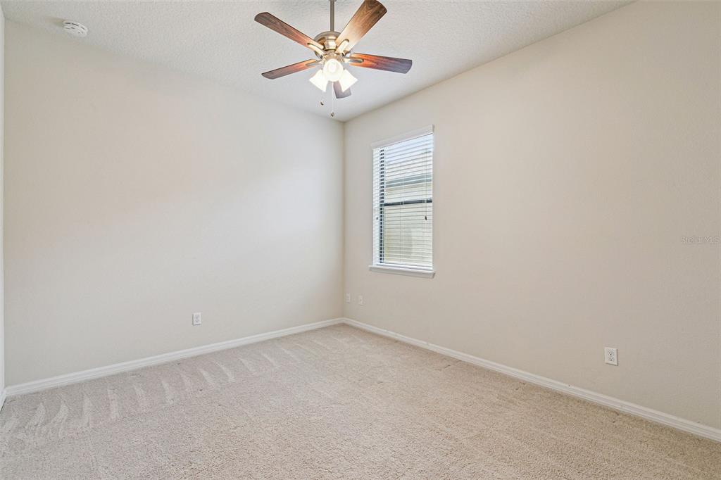 7137 Beek Street Windermere, FL 34786 - Photo 22 of 33 an empty room with windows and fan