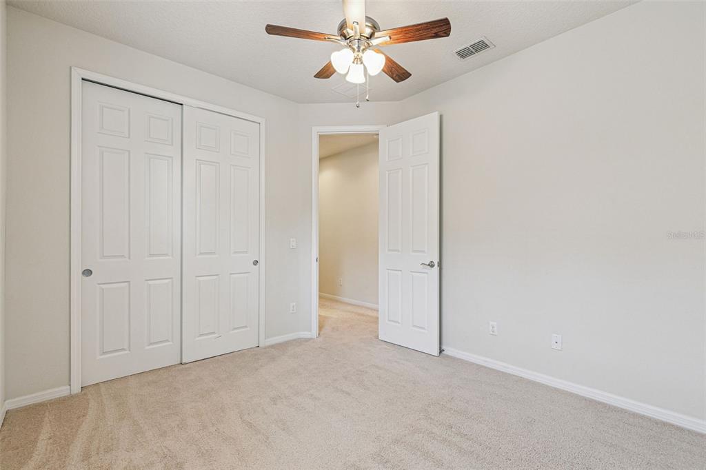 7137 Beek Street Windermere, FL 34786 - Photo 24 of 33 an empty room with closet and a chandelier fan