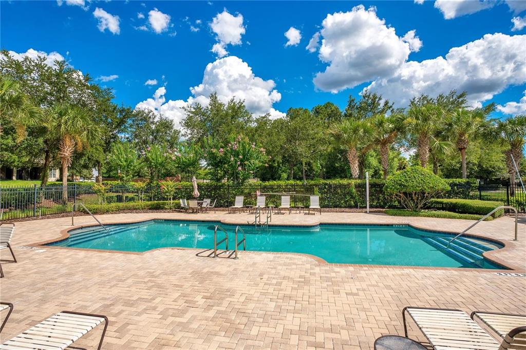 7137 Beek Street Windermere, FL 34786 - Photo 25 of 33 a view of a swimming pool with an outdoor space and seating area