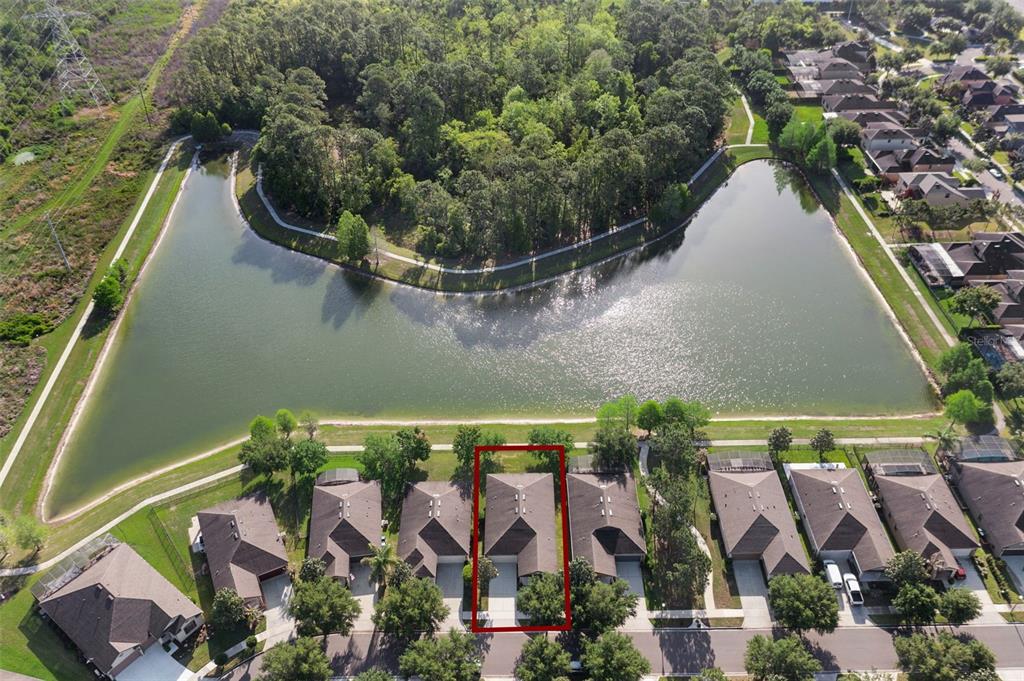 7137 Beek Street Windermere, FL 34786 - Photo 3 of 33 an aerial view of a house with a yard and lake view