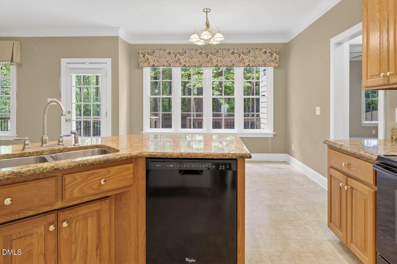 2209 Lodestar Drive Raleigh, NC 27615 - Photo 8 of 50 a large kitchen with granite countertop a sink and a stove