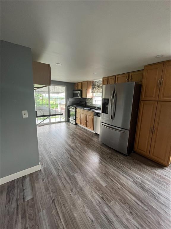 2107 Butler Logan Road Tarentum, PA 15084 - Photo 5 of 19 a kitchen with stainless steel appliances wooden floors and wooden cabinets