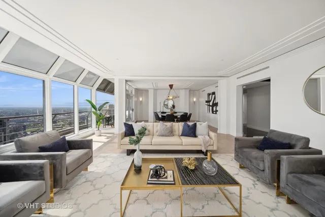 a living room with furniture a large window and a table