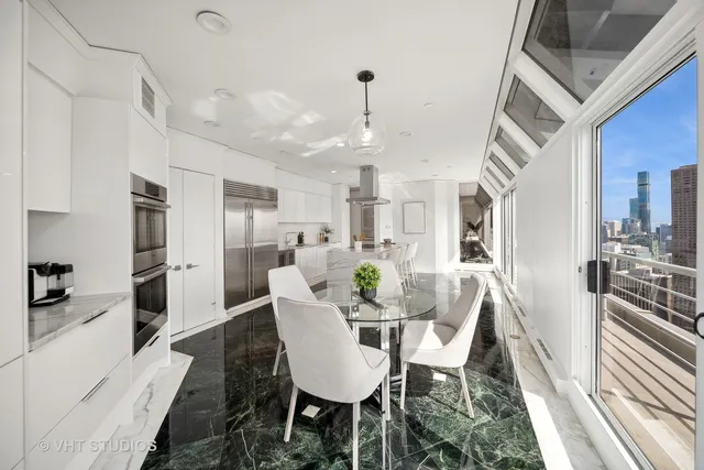 a view of a dining room with furniture and a kitchen view