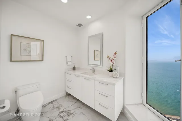 a bathroom with a sink a toilet and mirror