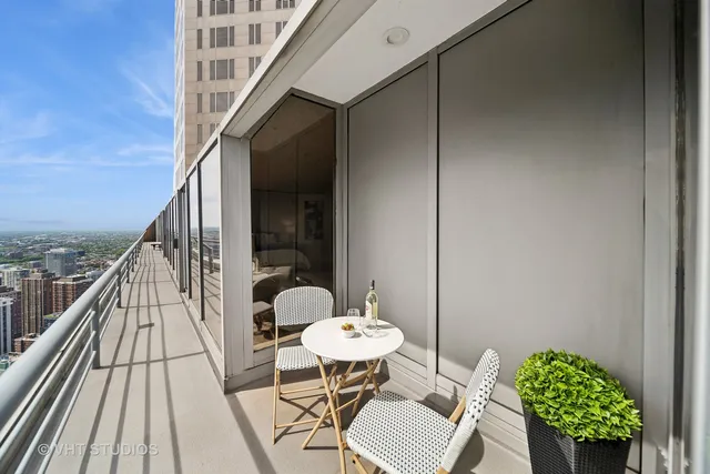 a balcony with table and chairs