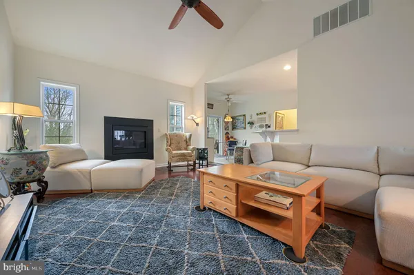 a living room with furniture and kitchen view