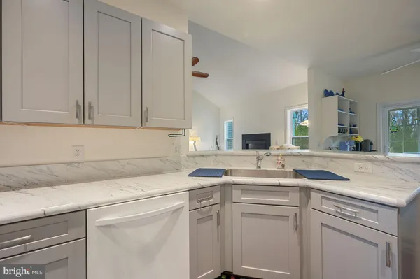 a view of a dining room with furniture and a chandelier