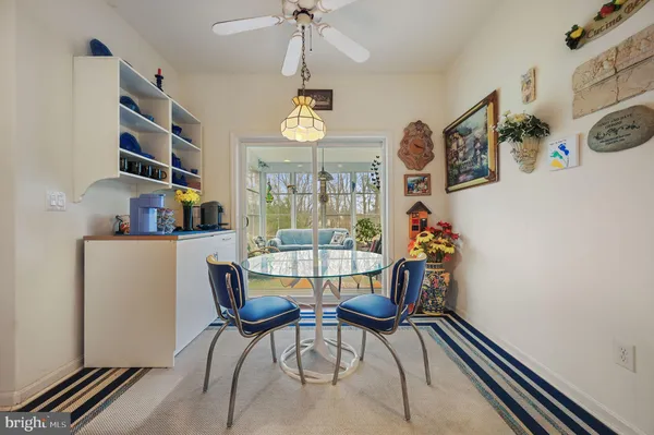 a dining room with furniture a chandelier and wooden floor