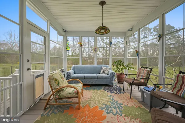 a spacious bedroom with a bed a chandelier and a large window