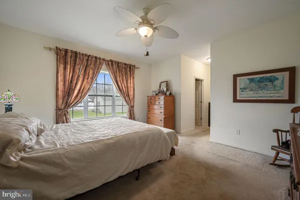 a bathroom with double vanity and a mirror