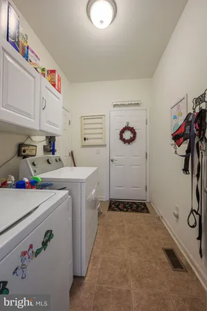 a roof deck with table and chairs and potted plants