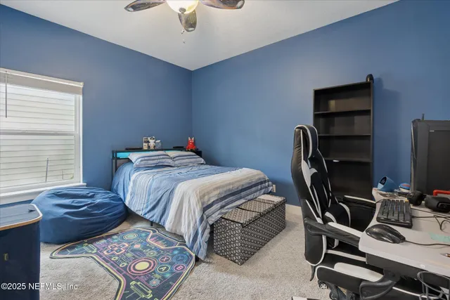 a bedroom with a bed and a chair