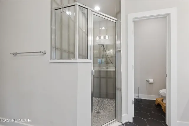 a bathroom with a glass shower door
