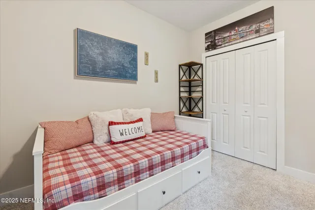 a bedroom with a bed and a painting on the wall