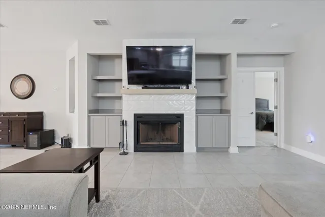 a living room with furniture a flat screen tv and a fireplace