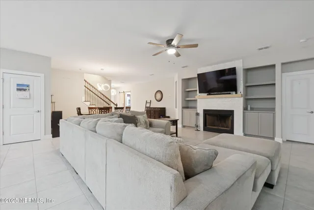 a living room with furniture a fireplace and a flat screen tv
