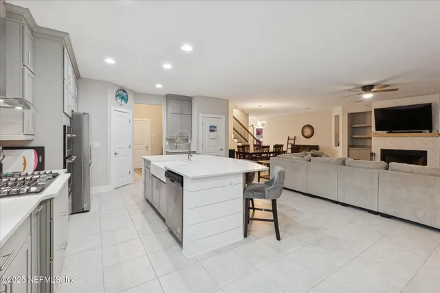 a kitchen with stainless steel appliances kitchen island granite countertop a sink and cabinets