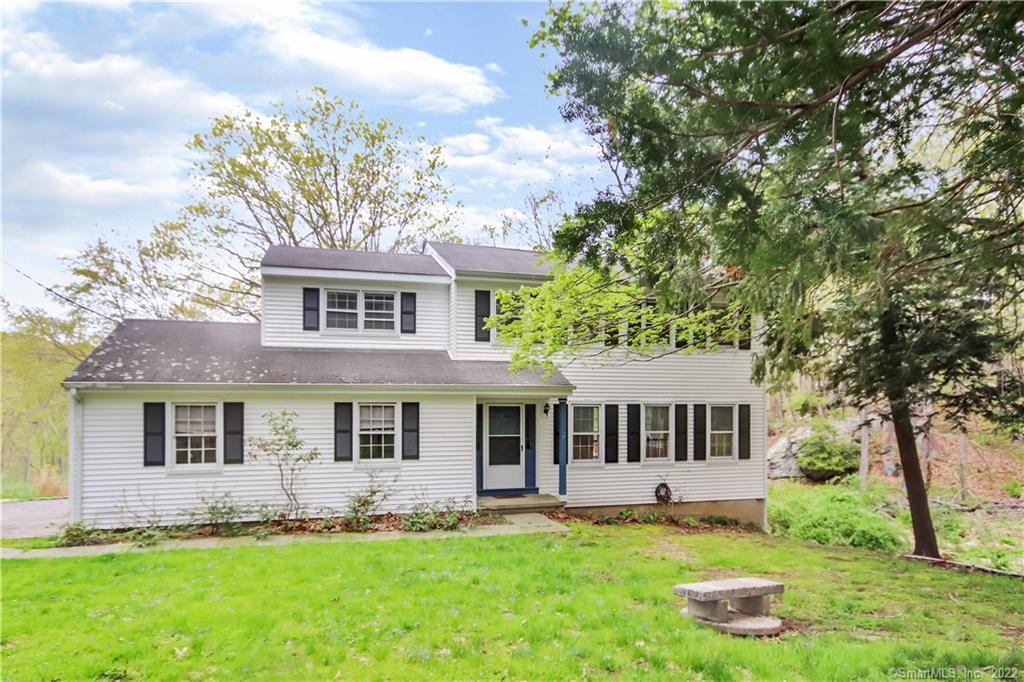 101 Mountain Road Redding, CT 06896 - Photo 1 of 1 a front view of a house with a garden and yard