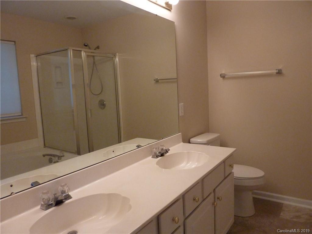 3607 Marbury Road Charlotte, NC 28269 - Photo 11 of 16 a bathroom with a sink toilet and shower