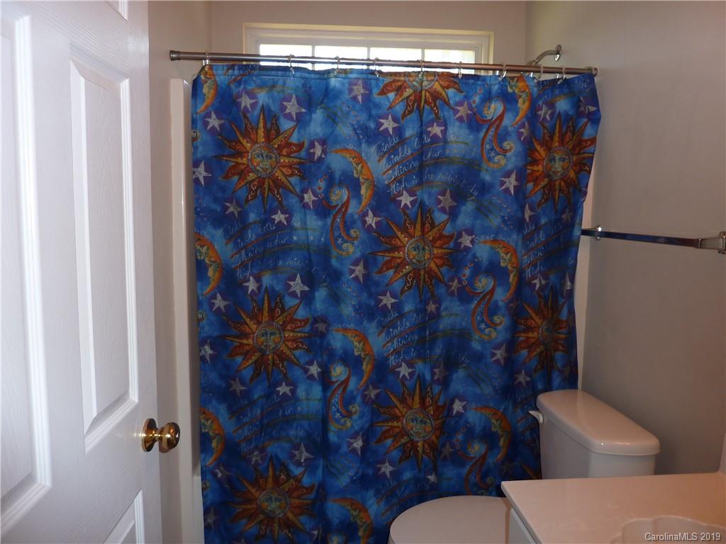 3607 Marbury Road Charlotte, NC 28269 - Photo 15 of 16 a bathroom with a toilet and a shower curtain