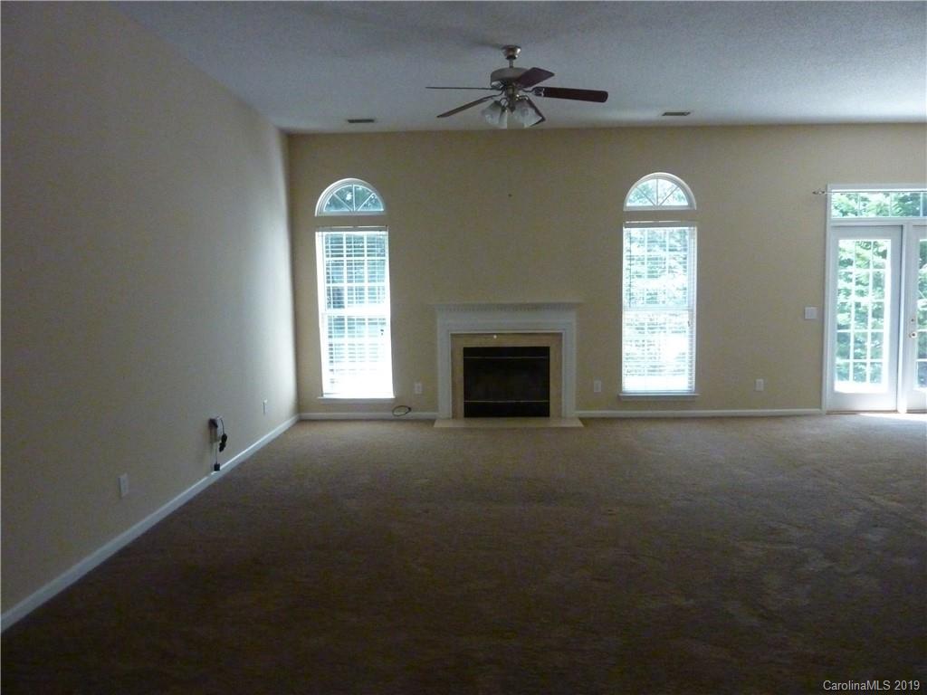 3607 Marbury Road Charlotte, NC 28269 - Photo 3 of 16 a view of empty room with windows and fireplace