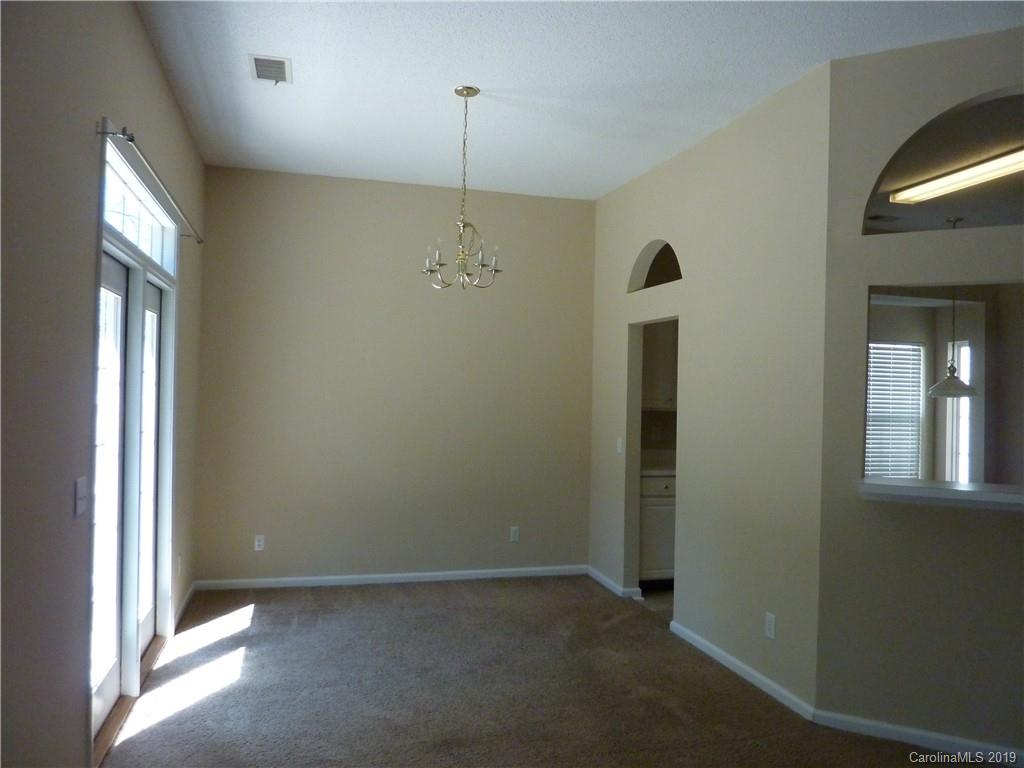 3607 Marbury Road Charlotte, NC 28269 - Photo 5 of 16 wooden floor in an empty room with a window