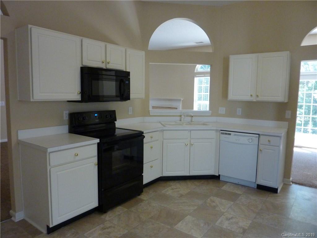 3607 Marbury Road Charlotte, NC 28269 - Photo 8 of 16 a kitchen with cabinets stainless steel appliances and a sink