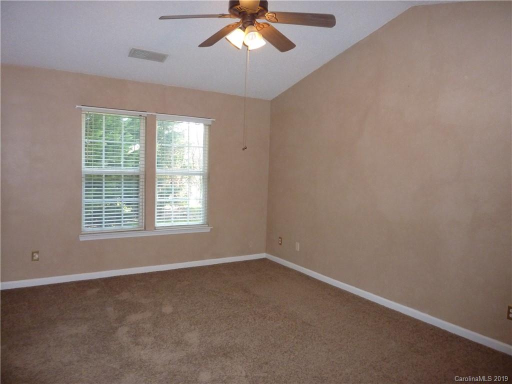 3607 Marbury Road Charlotte, NC 28269 - Photo 9 of 16 an empty room with a window and a fan