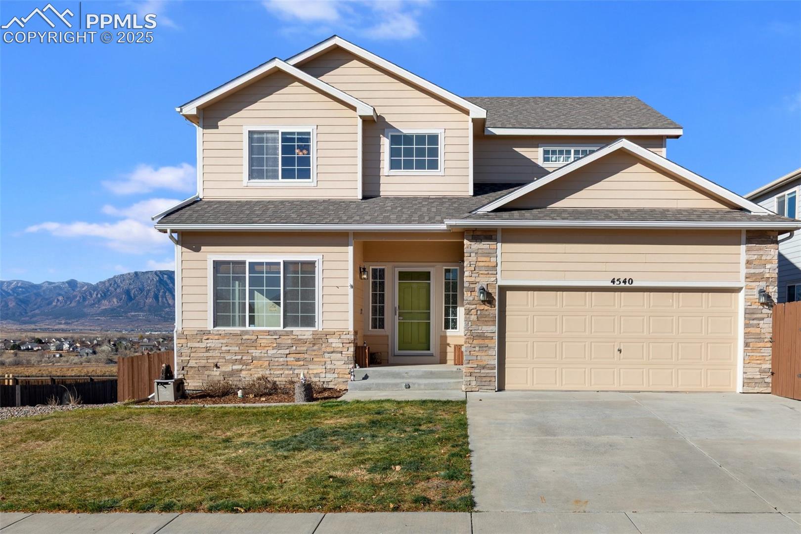 Craftsman-style house with driveway, a shingled roof, stone siding, and a garage