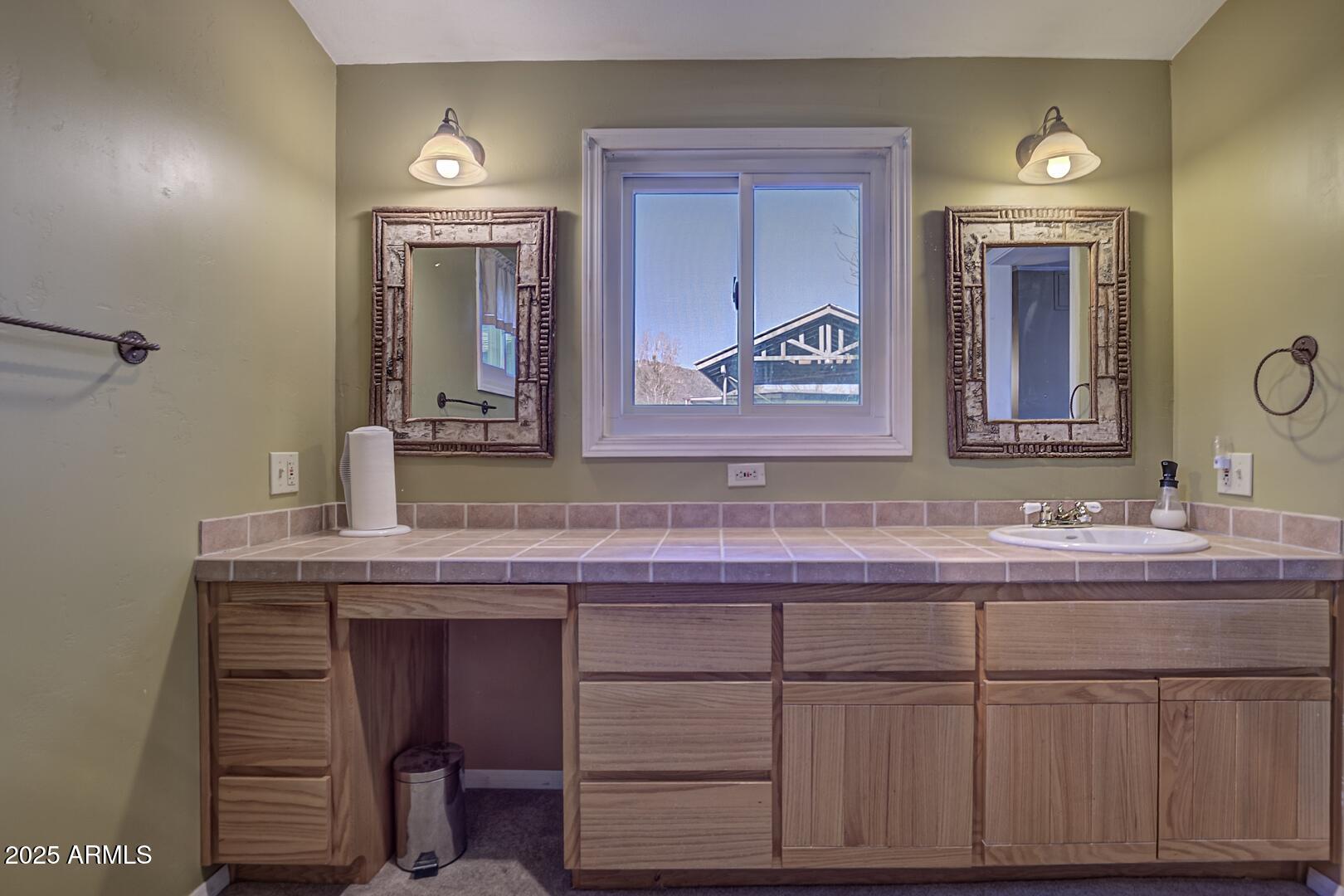 6066 S Road Pine, AZ 85544 - Photo 19 of 38 a bathroom with a sink and a mirror