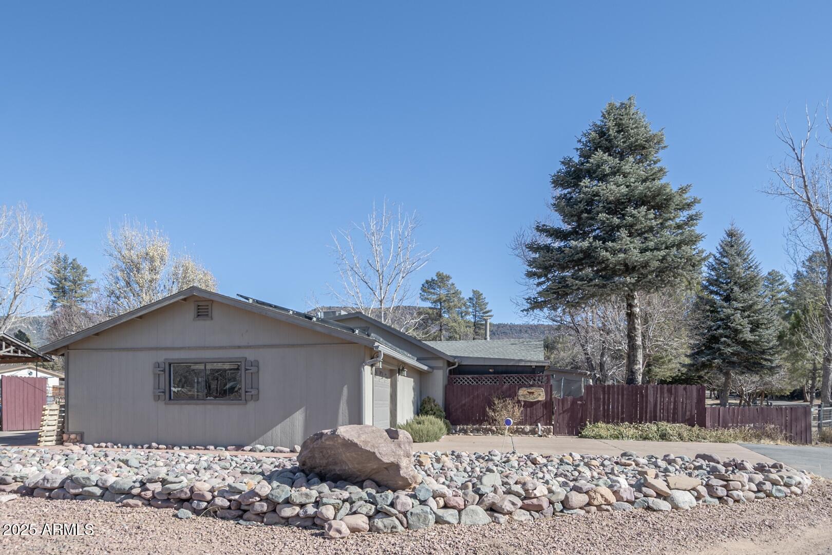 6066 S Road Pine, AZ 85544 - Photo 23 of 38 a front view of a house with a yard
