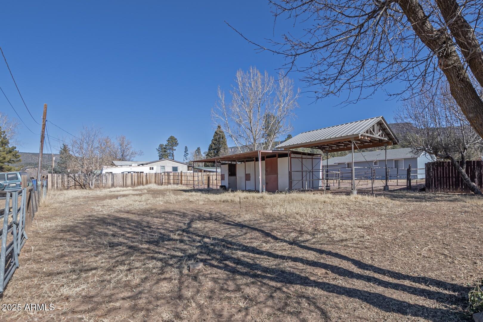 6066 S Road Pine, AZ 85544 - Photo 31 of 38 a big room with large trees and a wooden fence
