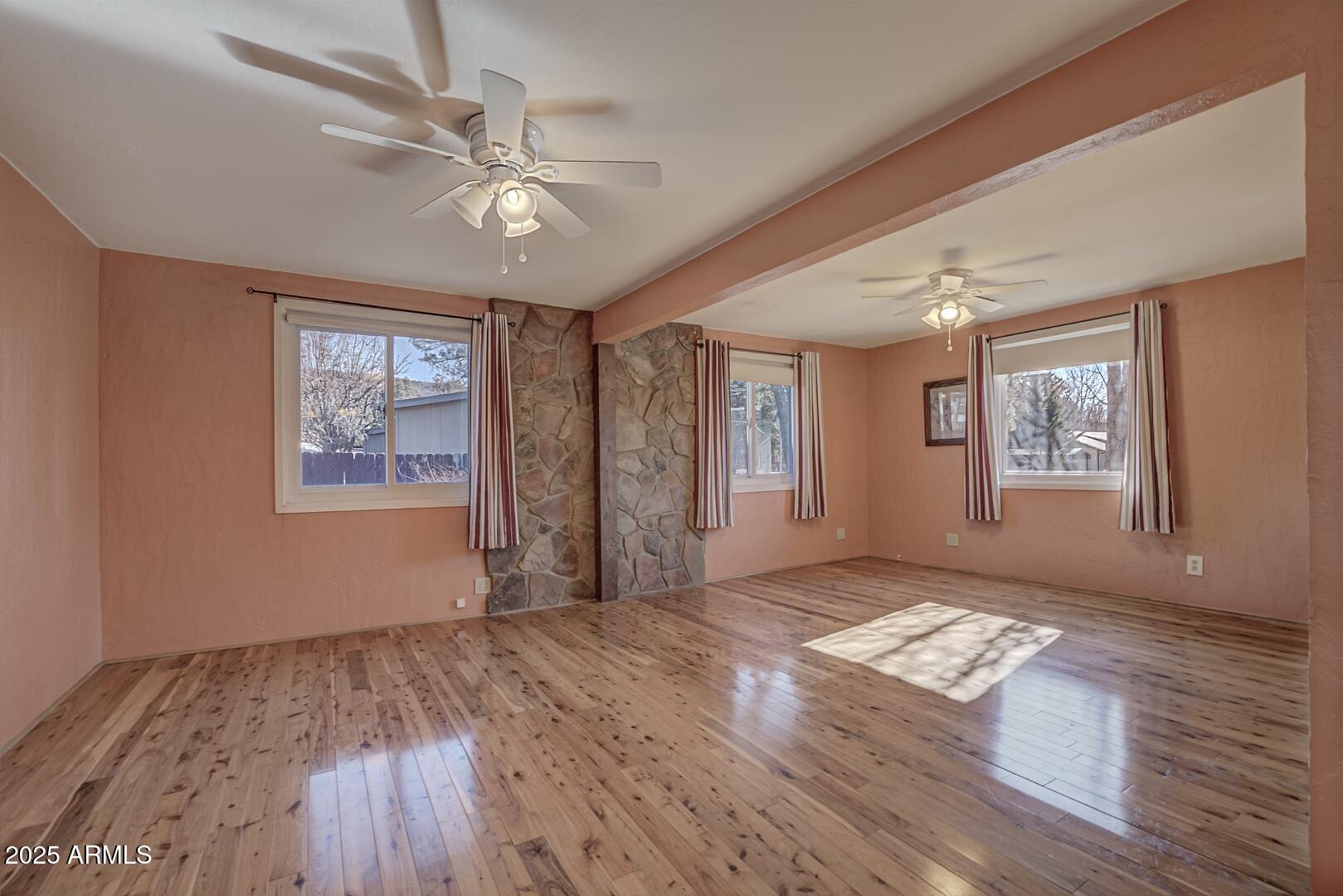 6066 S Road Pine, AZ 85544 - Photo 7 of 38 a view of an empty room with a window and wooden floor