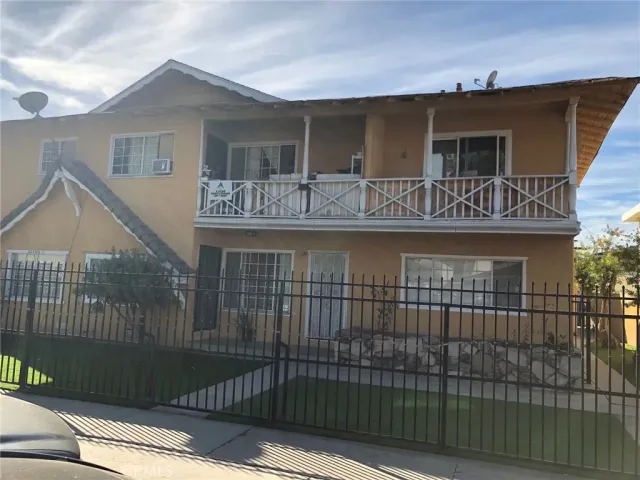 a front view of house yard and car parked
