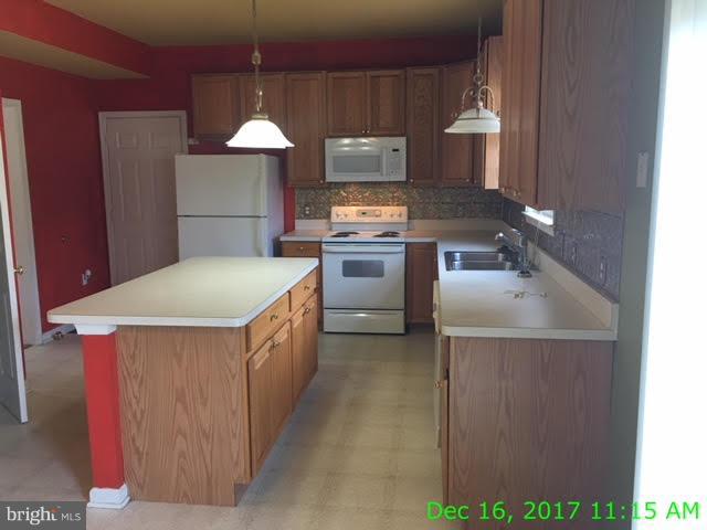 6990 Stuart Road King George, VA 22485 - Photo 2 of 15 a kitchen with stainless steel appliances granite countertop a sink a stove and a refrigerator