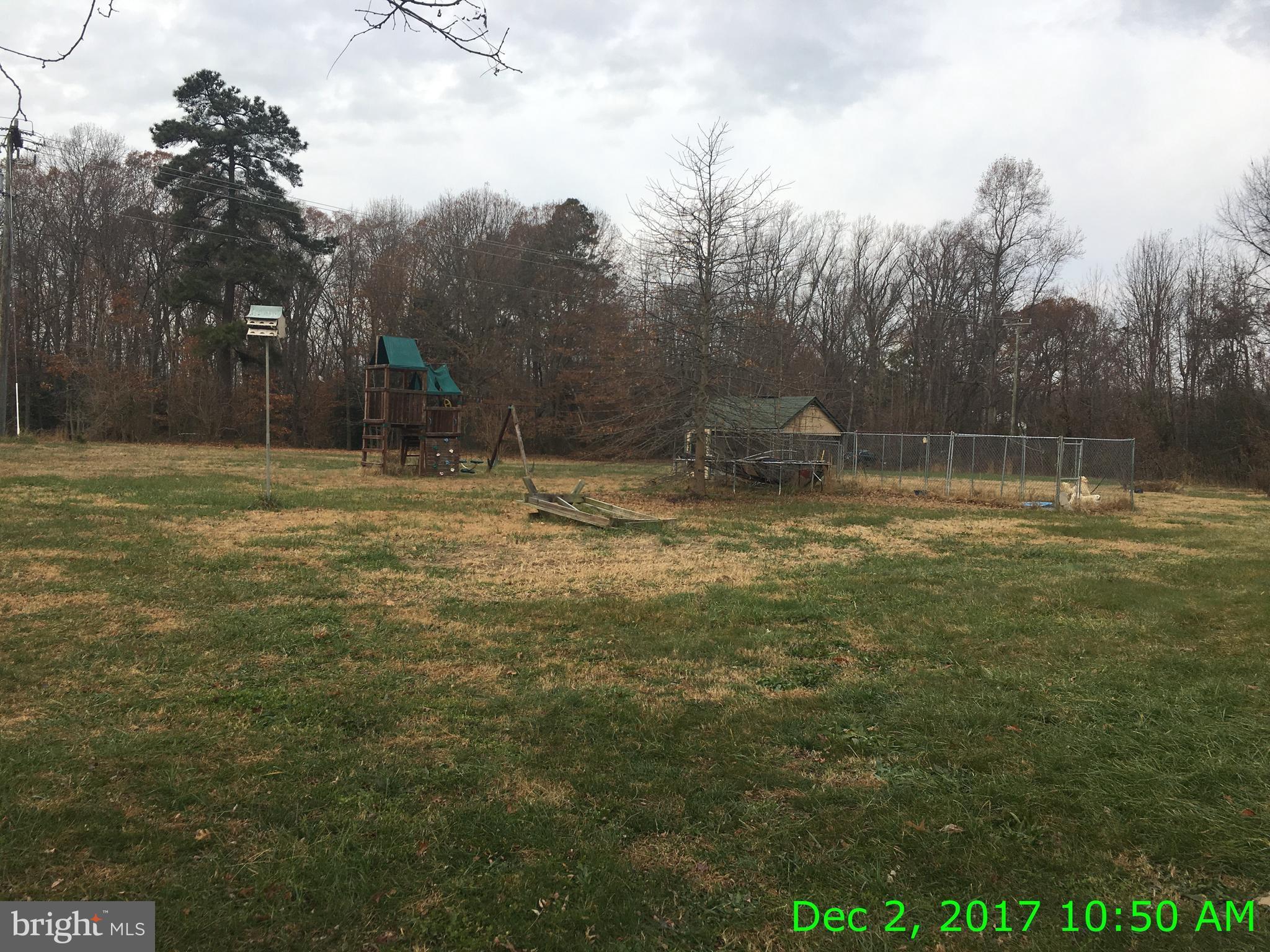 6990 Stuart Road King George, VA 22485 - Photo 14 of 15 a backyard of a house with lots of green space