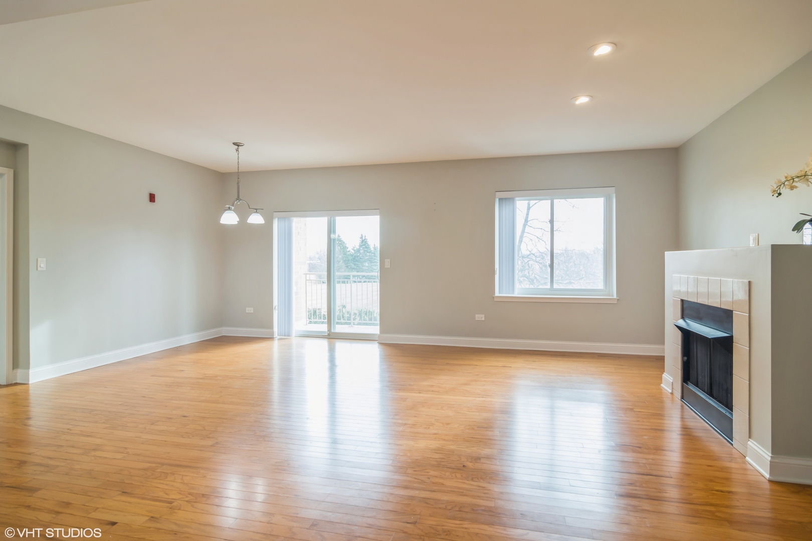 125 North Buffalo Grove Road, Unit 110 Buffalo Grove, IL 60089 - Photo 2 of 14 a view of an empty room with a window and wooden floor